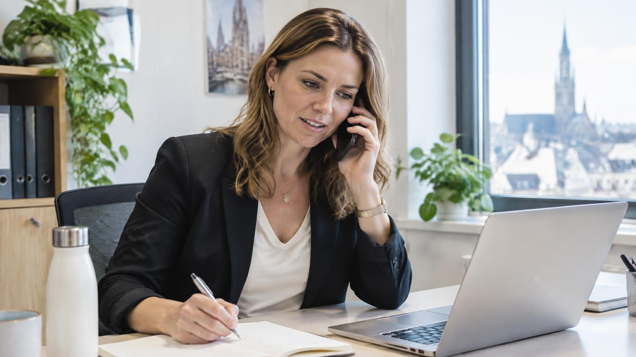 Person answering phone calls at a bright office desk