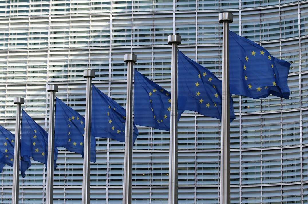 European institutional building facade with flags